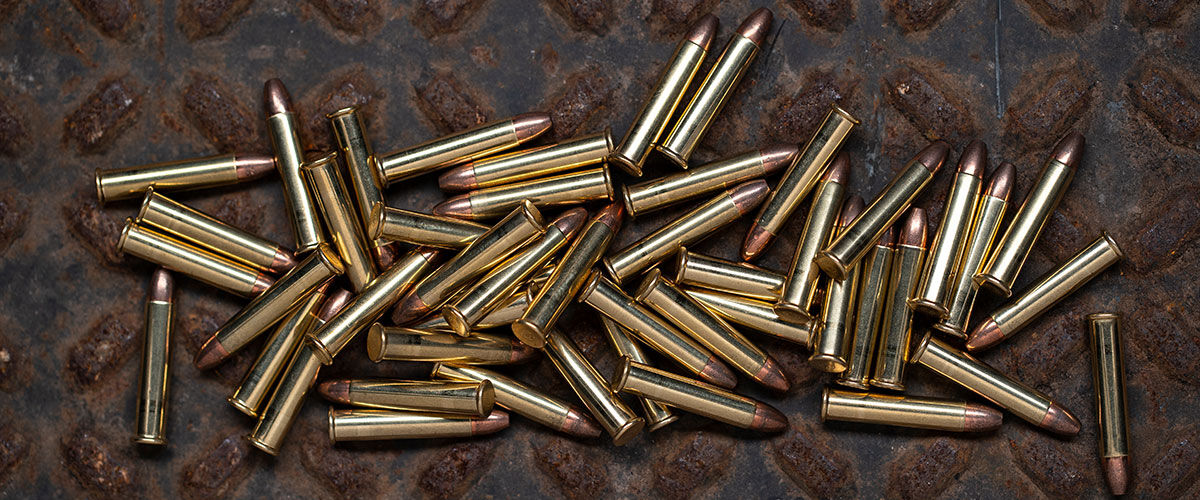 22 WMR cartridges laying on a rusted metal sheet