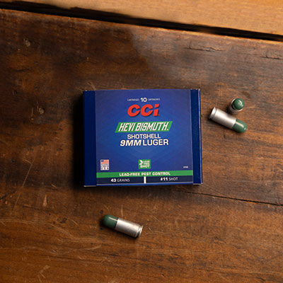 HEVI-Bismuth Shotshell box and cartridges laying on a table