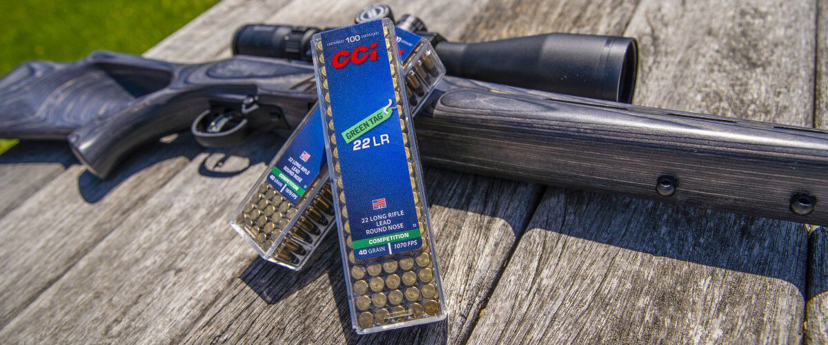 Rifle and CCI Green Tag ammo laying on a table