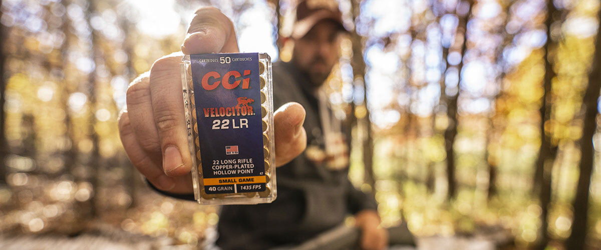 Hunter holding a box of CCI Velocitor 22 LR towards the camera 