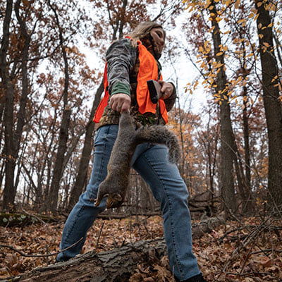 hunter carrying dead squirrel