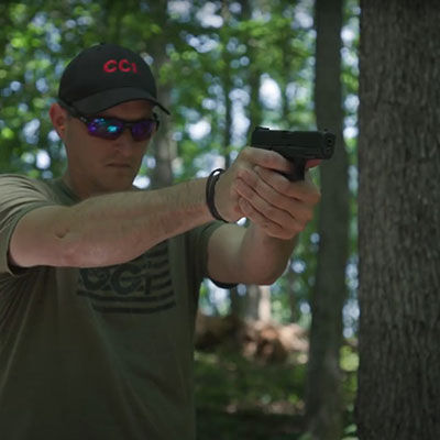 22plinkster looking down the scope of a rifle with a box of Uppercut on a table