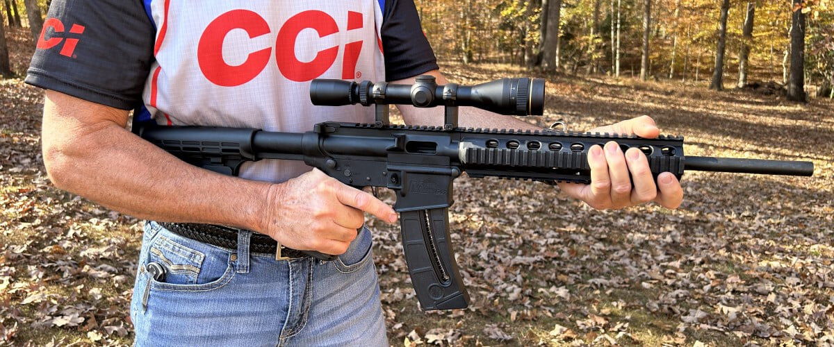 shooter holding a rifle at their abdomen