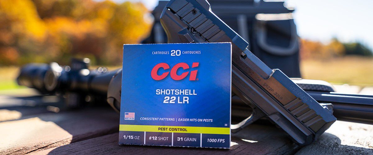 CCI Pest Control Packaging laying agains a rifle and handgun