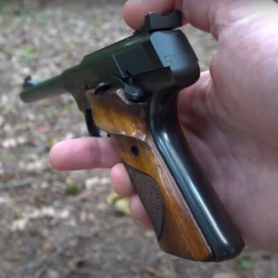 22plinkster holding a pistol in his hand