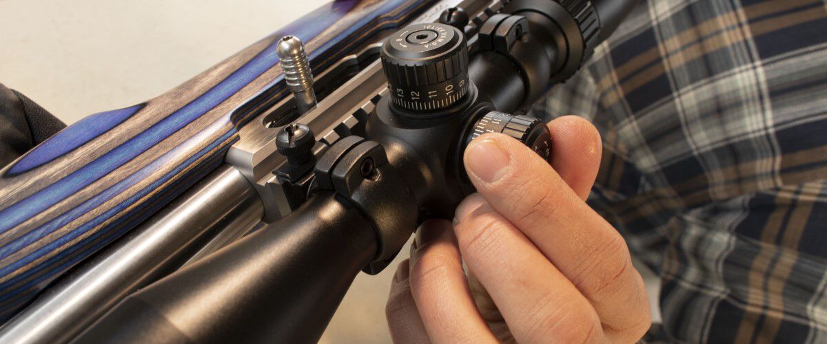 A Rifle Scope Being Adjusted