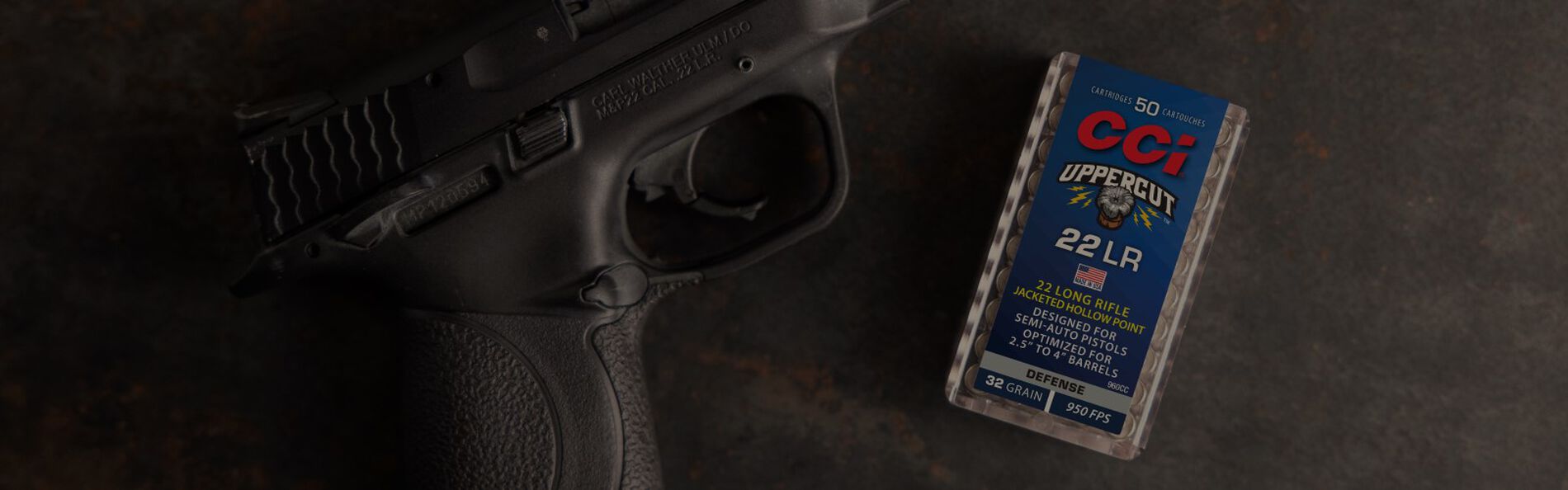 Uppercut packaging, handgun and cartridges laying on a table