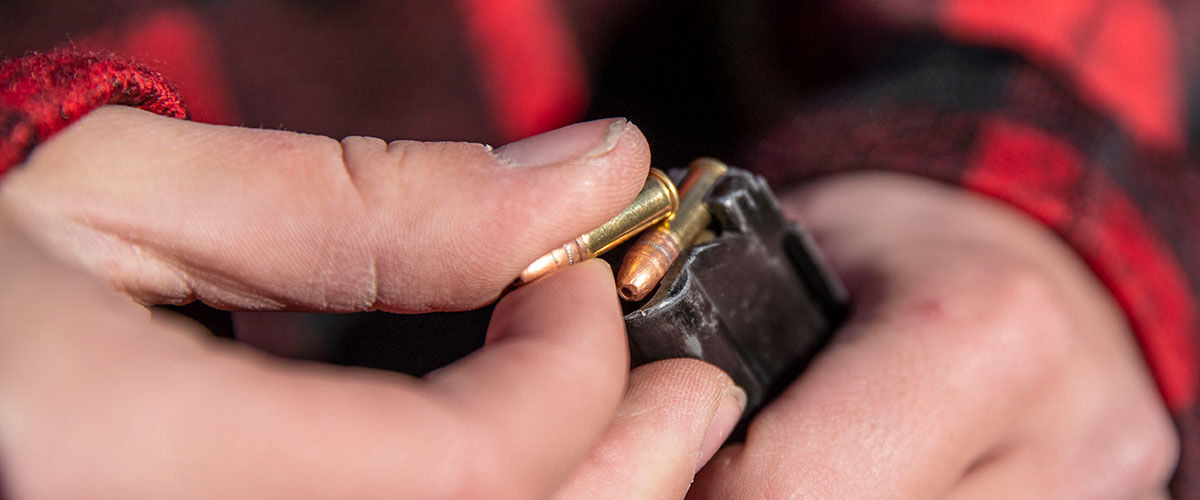 CCI ammunition being loaded into a magazine