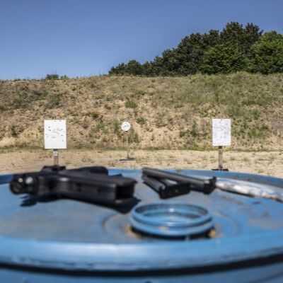 Outdoor Target Range with a Handgun resting on a blue barrel