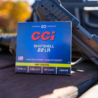CCI Pest Control packaging sitting on a table outside in front of a handgun