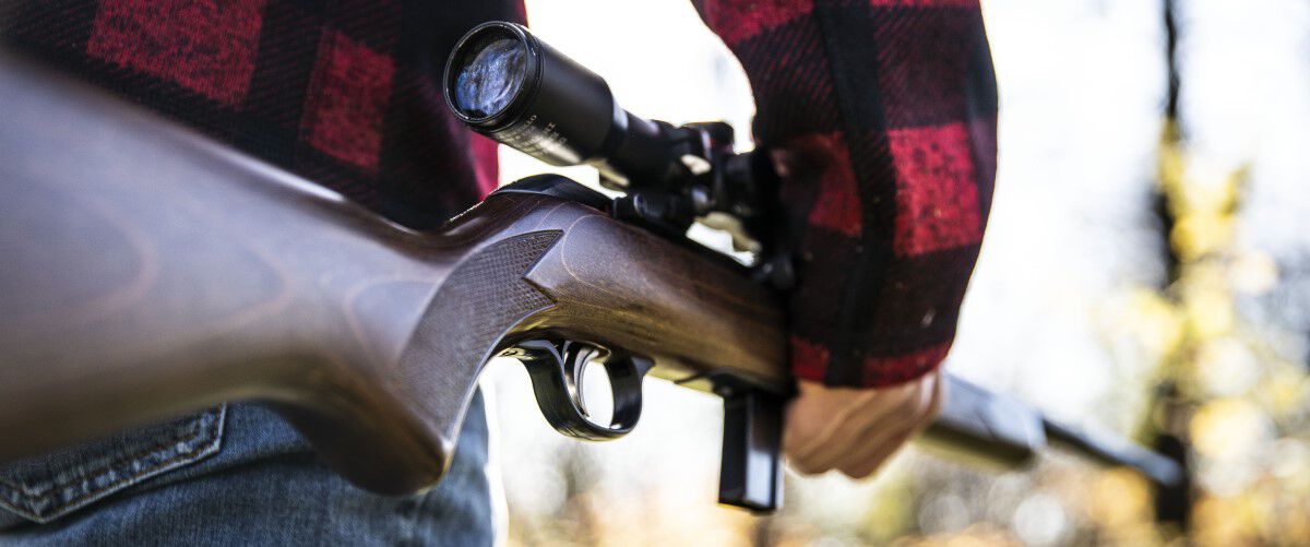 man aiming a rifle