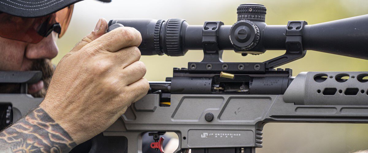 Man looking down the scope of a rifle