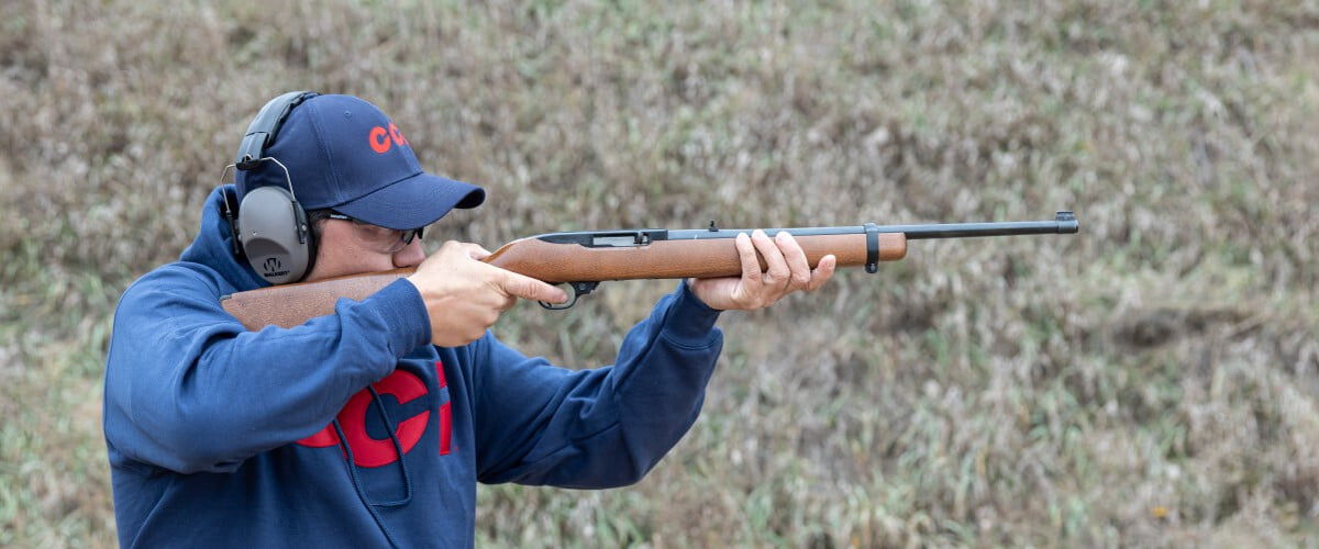 shooter looking down the iron sights of a rifle