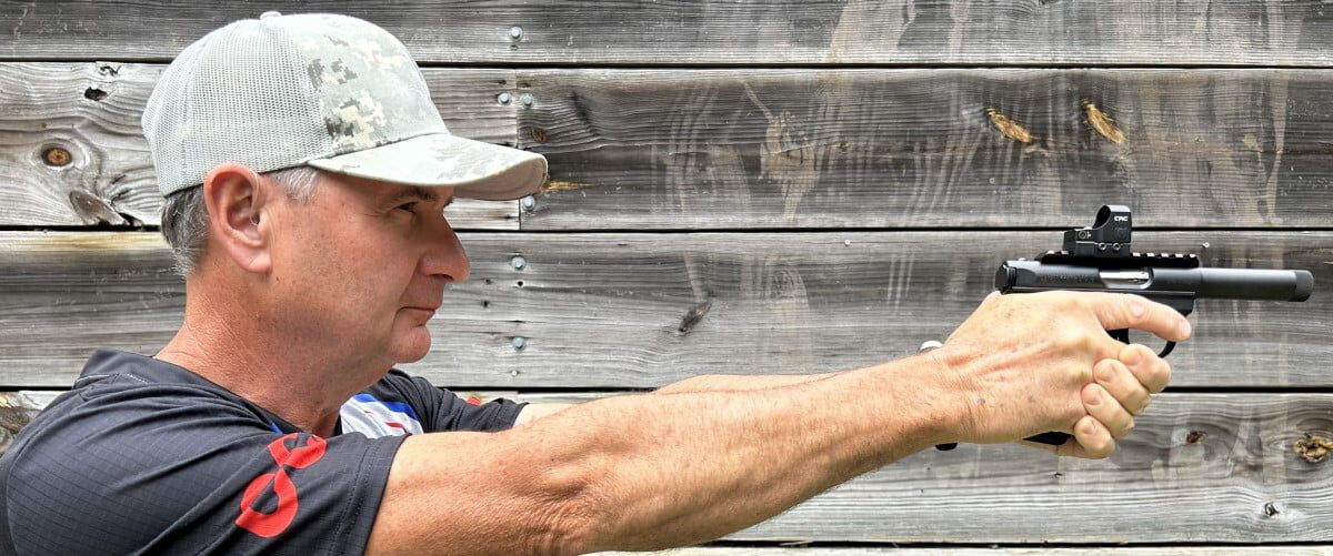 shooter holding a handgun with both hands