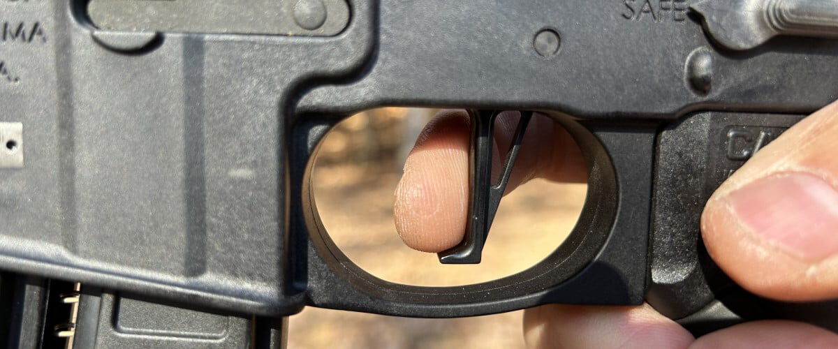 shooter with finger on the handgun trigger