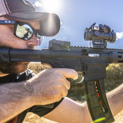 shooter looking down the scope of an ar rifle