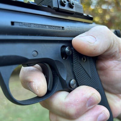 shooter with finger on the handgun trigger