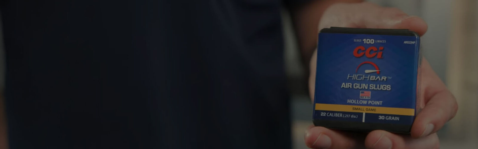 person holding a box of High Bar Air Gun