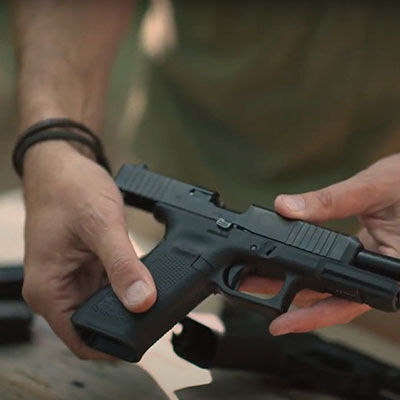 22plinkster holding rimfire handgun