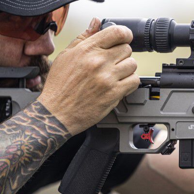 Man looking down the scope of a rifle