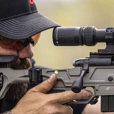 shooter looking down the scope of a rifle