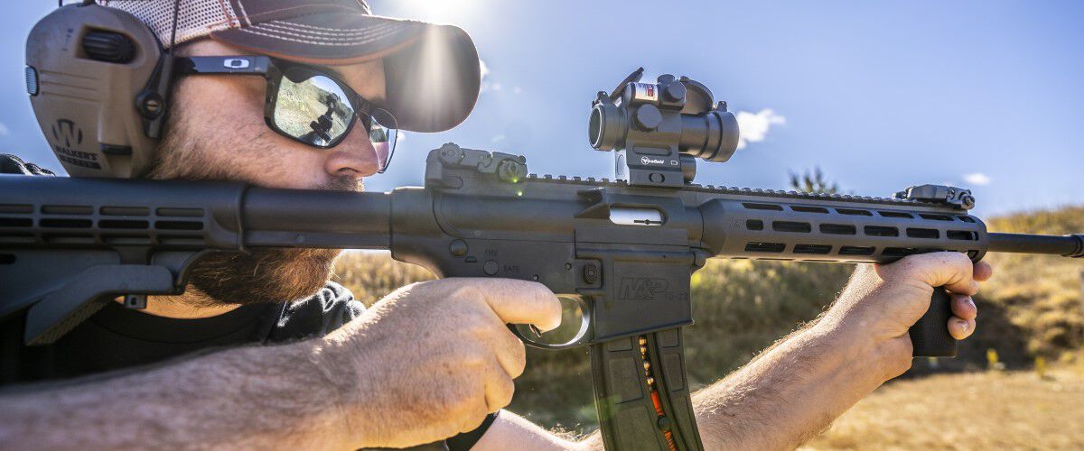 shooter looking down the scope of an ar rifle