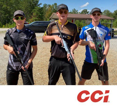 Chris Barrett, Cole Busch, and Gran Kunkel holding rifles
