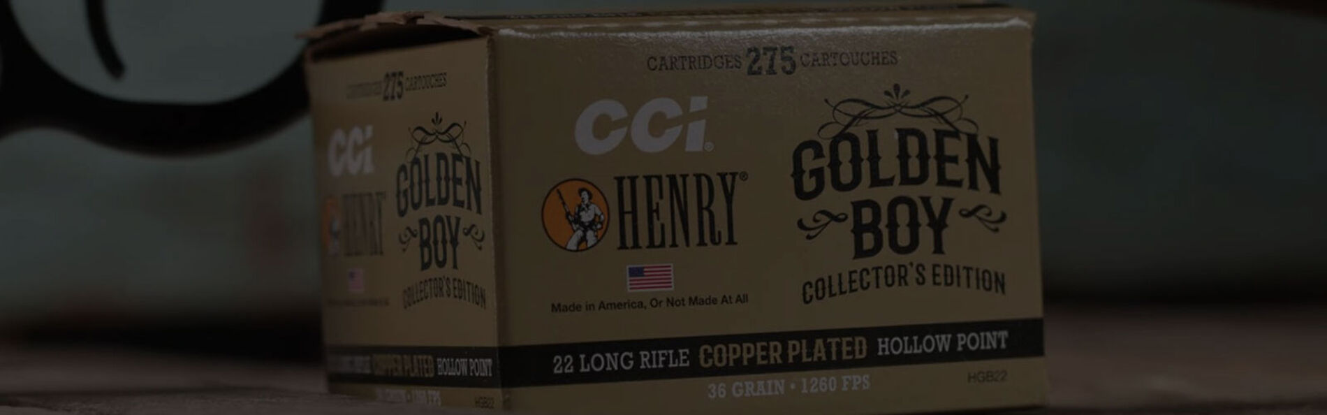 Golden Boy box in front of a Henry rifle