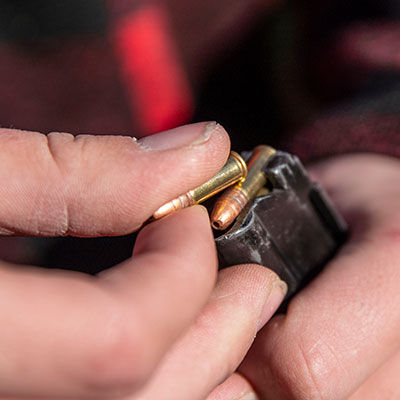 hunter loading CCI ammo into a magazine
