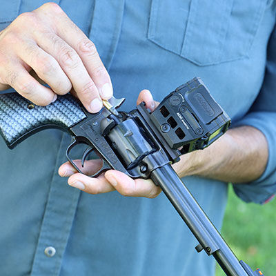 shooter loading CCI ammunition into a revolver